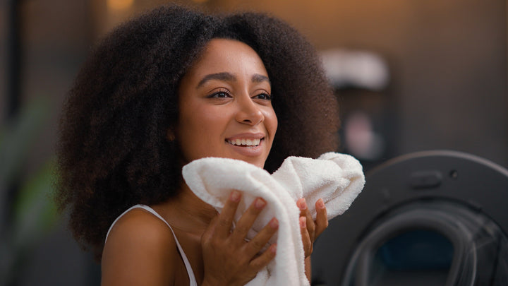 A woman holding a washed towel